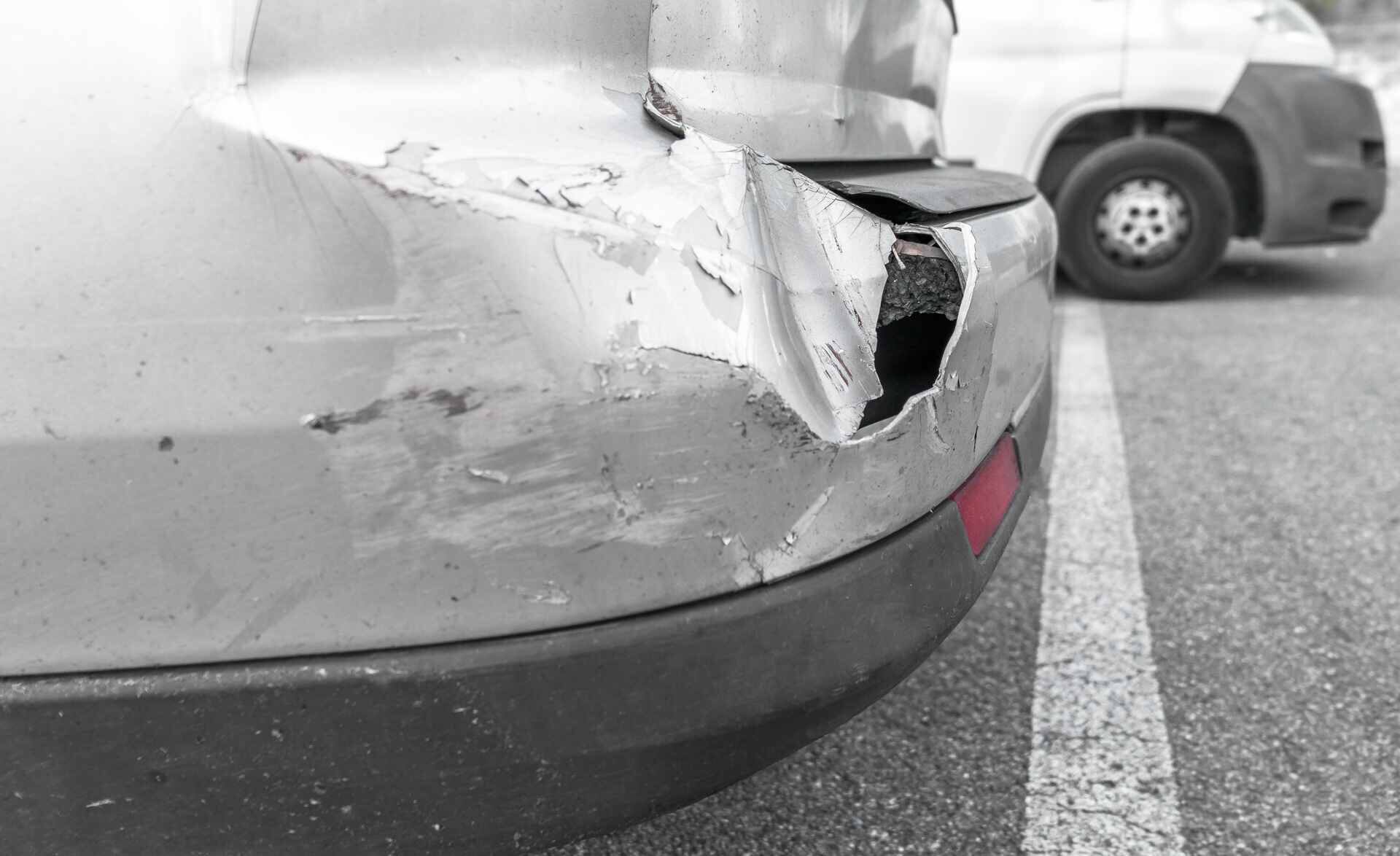 A car that is in need of bumper repair after an accident on a road in Minnesota
